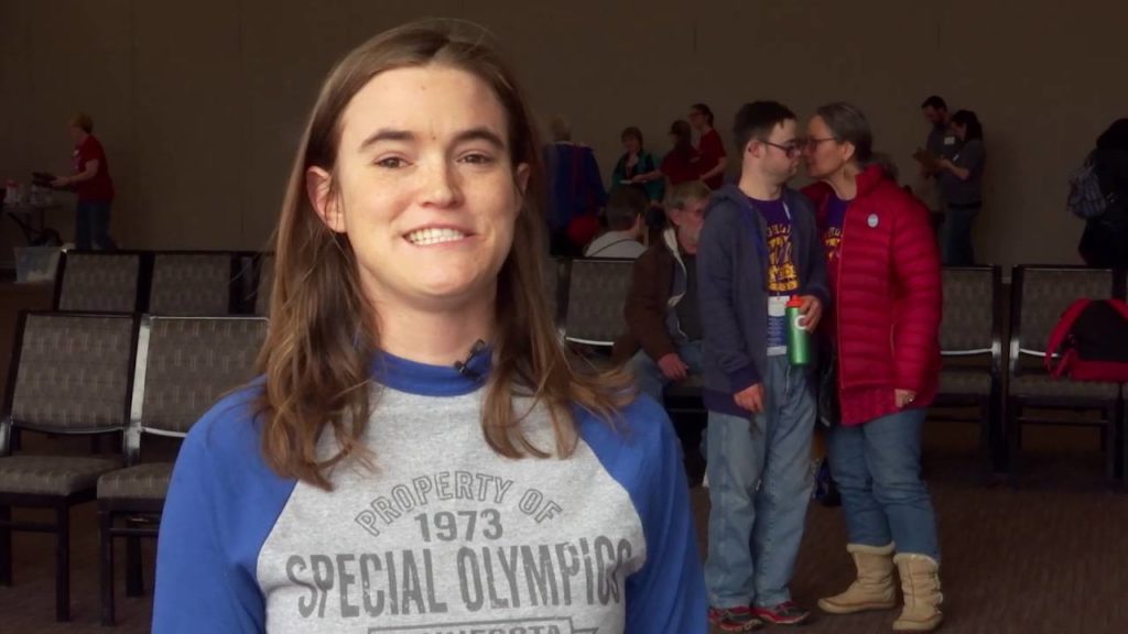 woman wearing a Special Olympics shirt and smiling