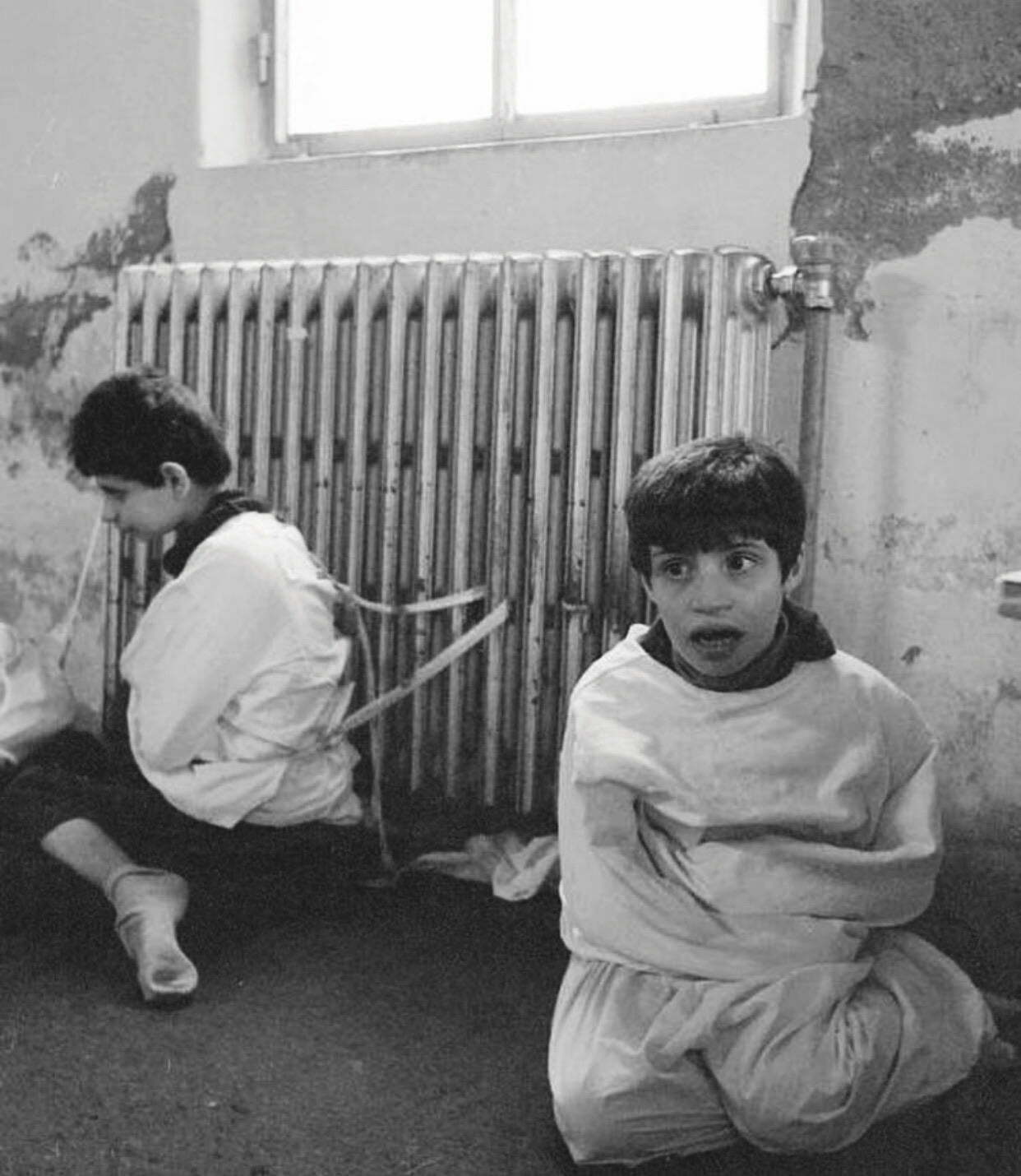 Children fettered to a radiator, at the Psychiatric hospital of Deir el Qamar