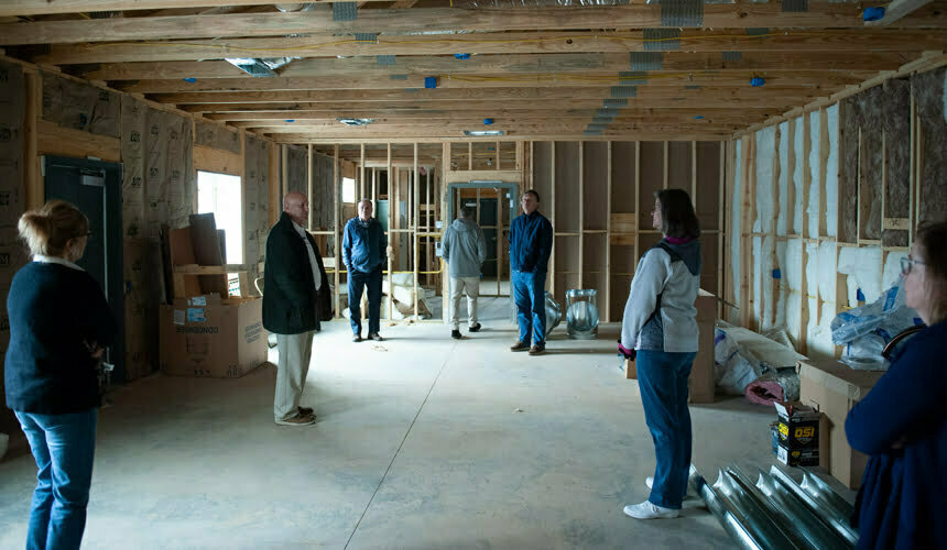 a group of people standing in a room under construction