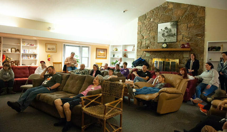 a group of people sitting around a living room