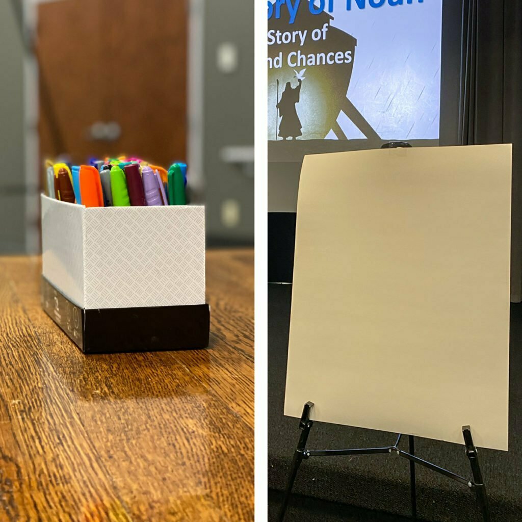 On the left: A small box of color markers sits on a classroom table.  On the right: A blank posterboard sits on an easel which is up on stage in the front of a classroom.