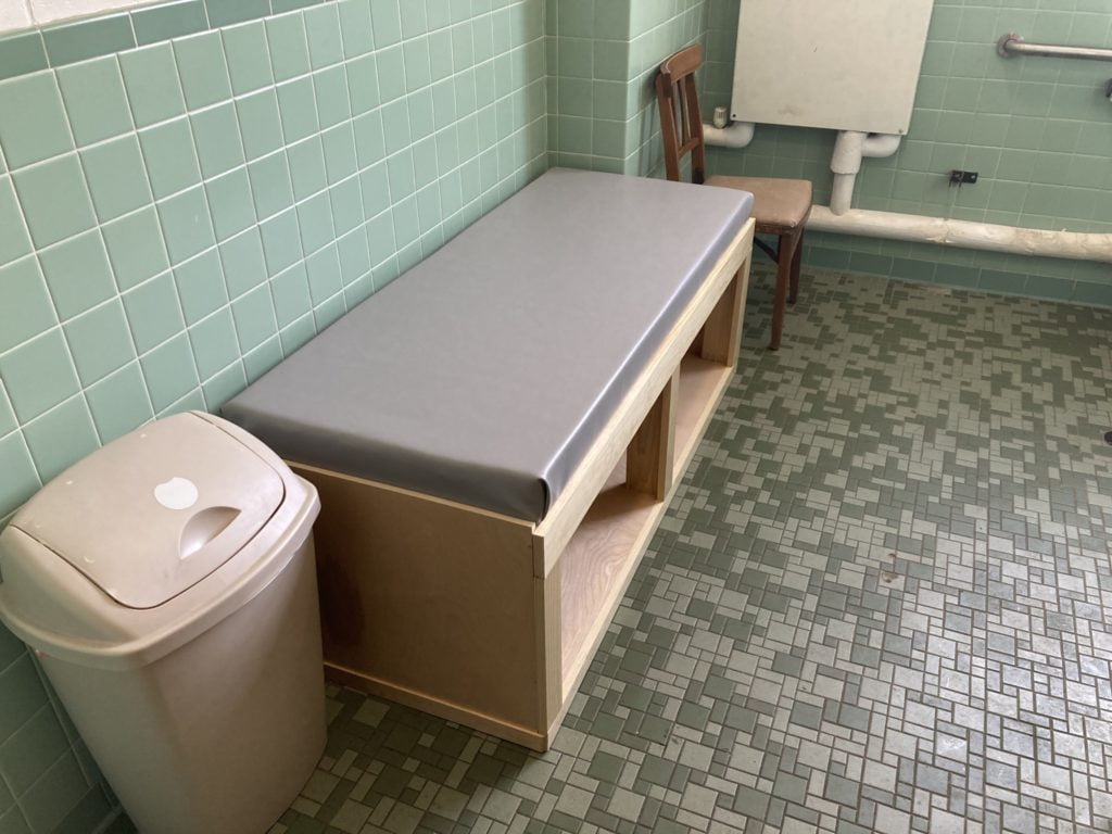 A DIY universal-sized changing table located in a restroom at a church.