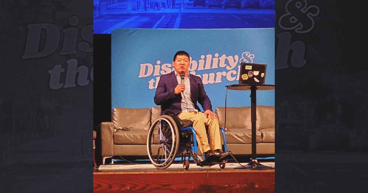 Minsoo Kim on stage speaking at Disability and the Church conference