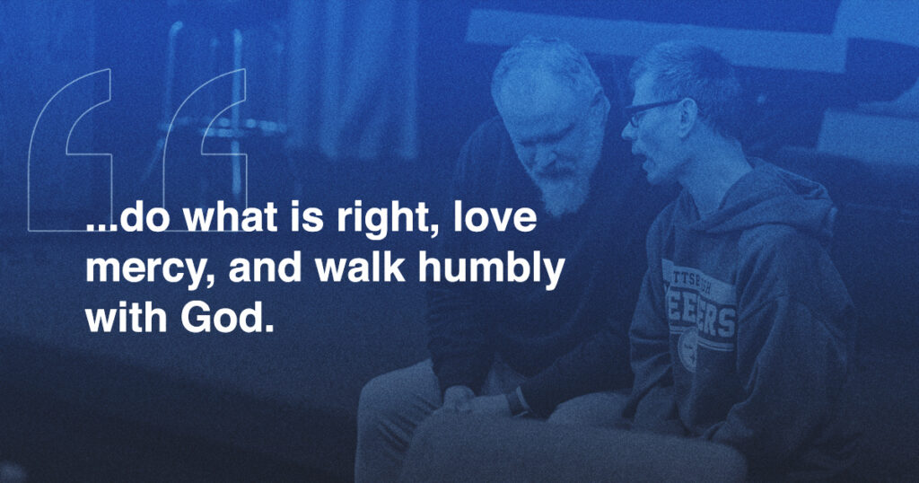 Two people sit and talk closely on a bench; overlaid text reads, ...do what is right, love mercy, and walk humbly with God. Walk This Way.